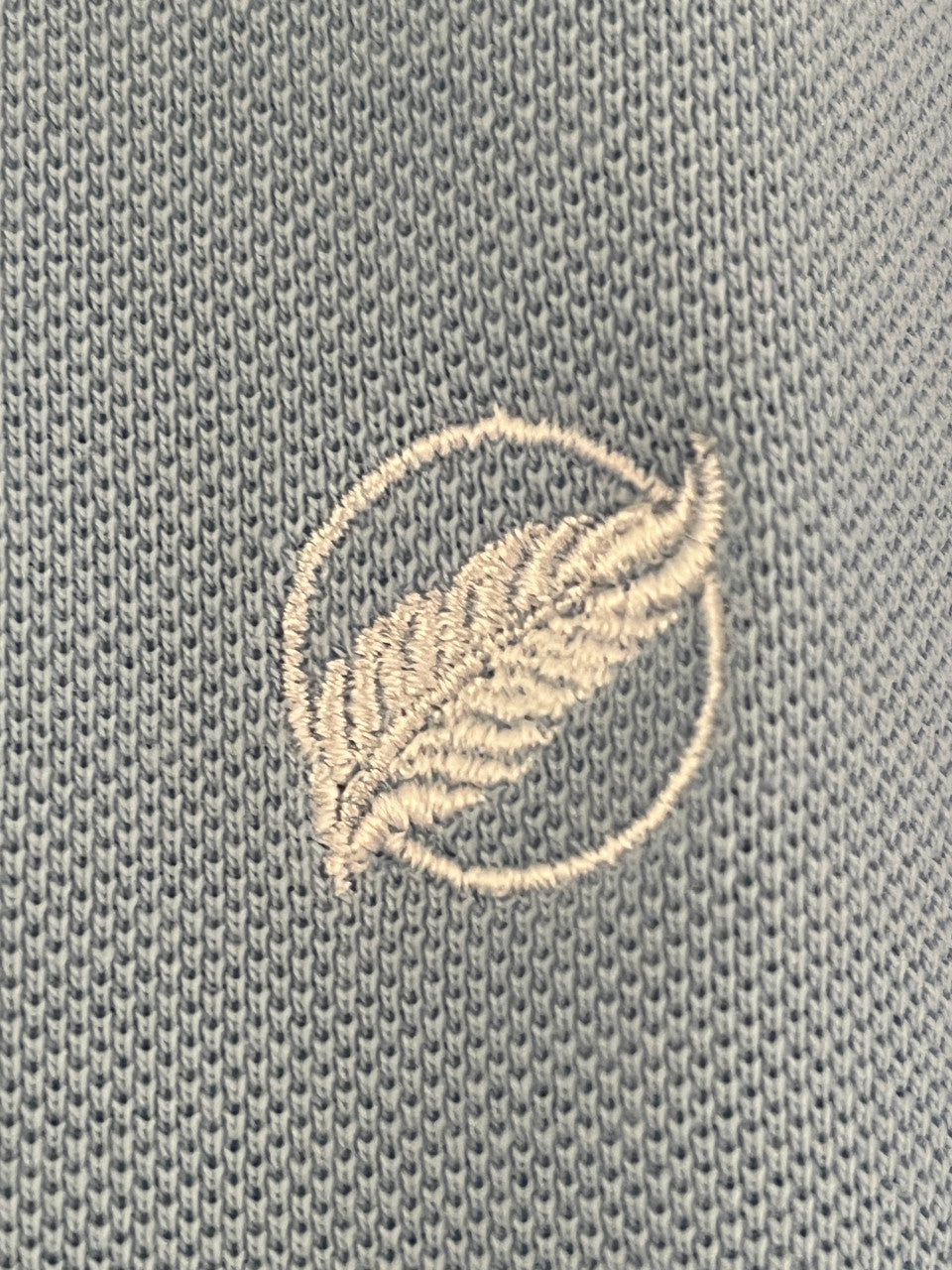 embroidered white feather logo