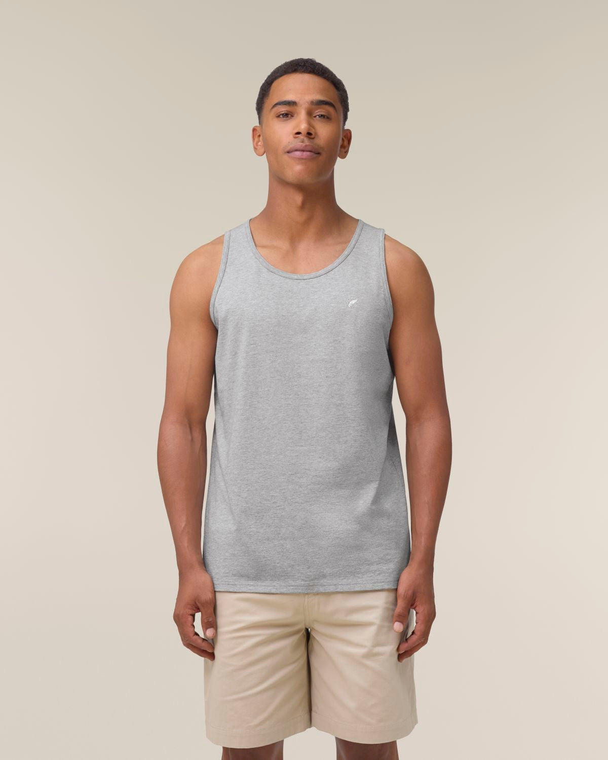 The Roho Rafiki® embroidered white feather icon vest (Men's) is a highly versatile addition to any eco-conscious wardrobe, thanks to a multitude of styling possibilities. This sleeveless staple has been modernised for comfort and fit, and is perfect as a layering tank top under a shirt for a neat, modern look, worn solo on warmer days, or at the gym. The quality vest is also supremely comfortable, offering ultimate freedom of movement. Heather Grey.